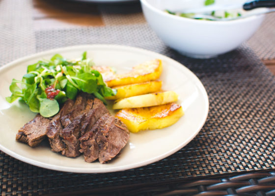 Beef steak with grilled pineapple and salad